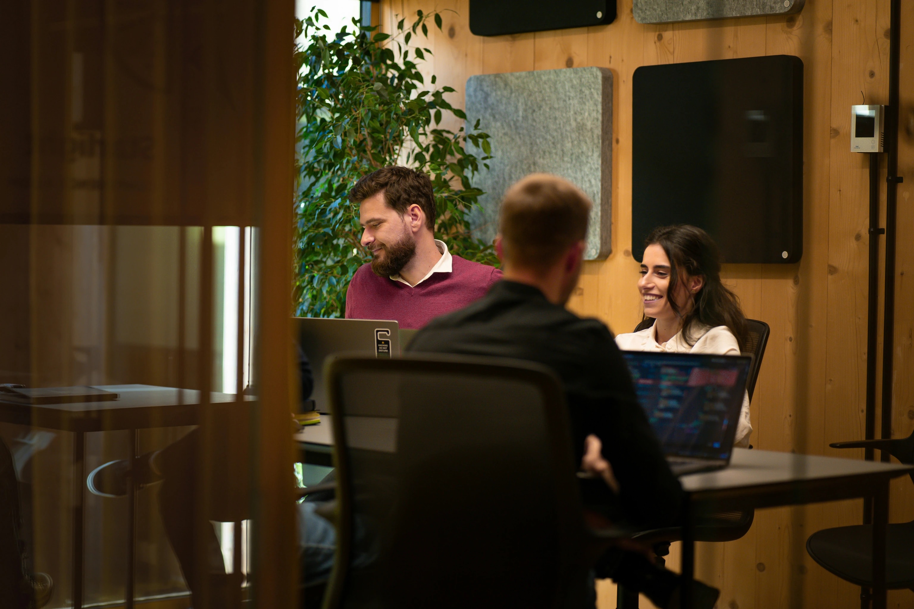 Colleagues working together in a warm, wood-paneled office